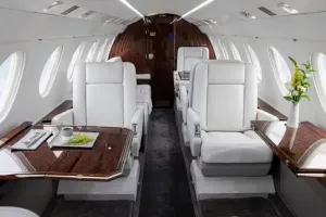 Spacious forward cabin of the 9-passenger Falcon 50EX, featuring the four-place club configuration with deployed executive tables