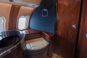 Luxury aft lavatory in Global XRS S/N 9234 featuring vanity with sink and wood finishes