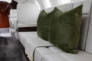 Close-up of the comfortable three-place divan in the aft cabin of the Falcon 50EX, perfect for relaxing during long flights