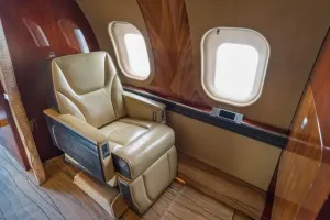 Global XRS private aft stateroom featuring a 3-place berthing divan and single executive seat